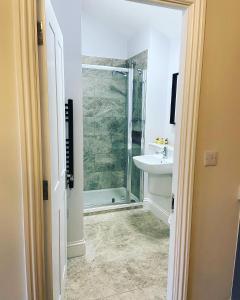 a bathroom with a shower and a sink at Tilly’s stable in Pattishall