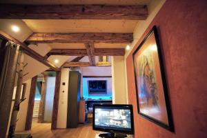 a living room with a tv and a painting on the wall at Ferienwohnung Ambiente in Gaggenau