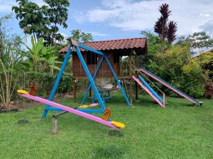 a group of playground equipment in the grass at QUINTA VACACIONAL DIEGO ALFONSO, MY house in Macas in Macas