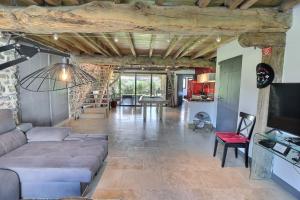 a living room with a couch and a table at Maison Muruzabal Etxea in Espelette
