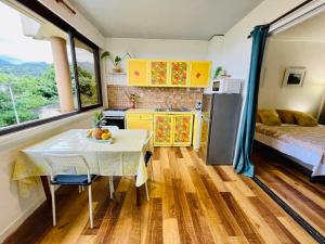 - une cuisine avec une table et un lit dans une chambre dans l'établissement Studio Hina - Cosy, Quiet & Pool, à Papeete