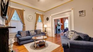 a living room with two couches and a table at Elegant 2 bed directly on Forsyth Park in Savannah