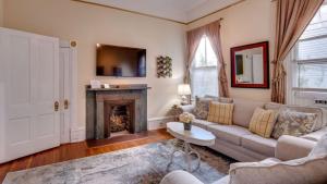 a living room with a couch and a fireplace at Forsyth Park 2 Bedroom Beauty in Savannah