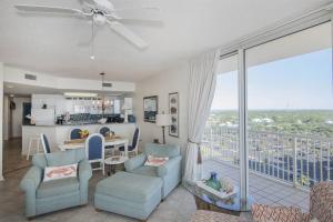 a living room with a table and chairs and a kitchen at Beach Club C1001 Amazing Corner Unit in Gulf Shores