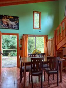 a dining room with a wooden table and chairs at Cabaña Rincón Verde in Villarrica