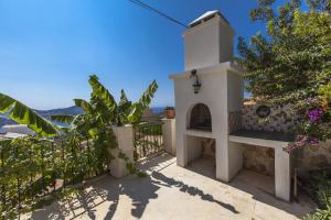 a small white building with a gate and flowers at Villa Asya in Kalkan