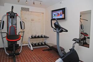 a gym with two exercise bikes and a television at Thon Hotel Sandnes in Sandnes