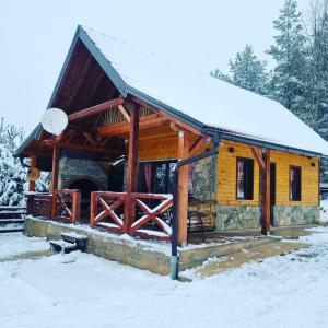a log cabin with a snow covered roof at Kuca za odmor Harmonija in Pale