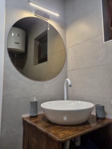 a bathroom with a white sink and a mirror at Kuca za odmor Harmonija in Pale