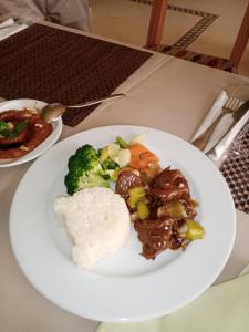 a plate of food with rice and vegetables on a table at New Memnon Hotel in Luxor