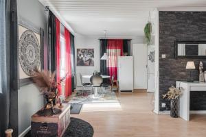 a living room with red curtains and a dining room at Guestly Homes - 4BR City Center Apartment in Piteå