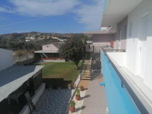 a balcony of a house with a view of a yard at Kefalos Studios Stamatia in Kefalos