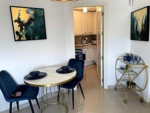 a kitchen with a table and chairs in a room at Couples Only, beautiful 1 Bedroom Apartment in Victoria Building in Mojácar +18 photos