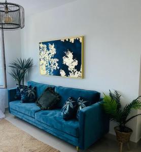 a blue couch with black pillows in a living room at Couples Only, beautiful 1 Bedroom Apartment in Victoria Building in Mojácar