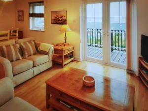 a living room with a couch and a coffee table at Ocean View in Port William