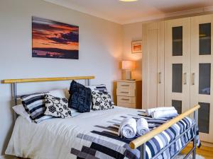 a bedroom with a bed with pillows on it at Ocean View in Port William