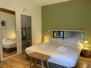 a bedroom with a large white bed and a mirror at Yorkshire Dales Lodge 17 Premium Ensuite in Richmond