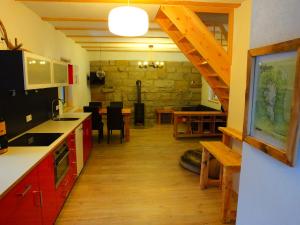 a kitchen with a staircase and a dining room at Waldhaus Bielatal in Bielatal
