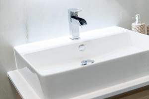 a white bathroom sink with a faucet at STILVOLLES APARTMENT in Vienna