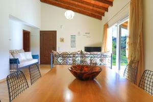 a dining room with a wooden table and chairs at Green Family Villa in Agios Ioannis