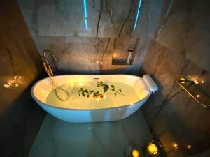 a bathroom with a tub with candles and lights at Rose Suite in Caesarea