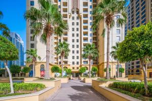 ドバイにあるLovely 2-bed condo in JBR - 5 mins from beach - Palm View!のヤシの木と建物が並ぶ街路