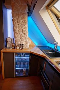 a kitchen with a counter with an open refrigerator at Ferienwohnung Ambiente in Gaggenau