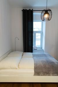 a white bed in a room with a window at STILVOLLES APARTMENT in Vienna