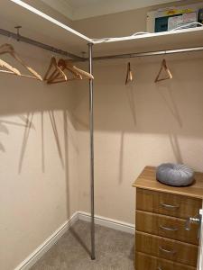 a closet with a bed and a desk and hangers at Windermere lodge,sleeps 6 in Windermere