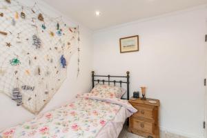 a bedroom with a bed and a rock wall at The Happy Hedgehog in Mundesley