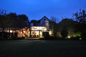 una casa grande por la noche con las luces encendidas en Domaine de L'Arbrelle, en Amboise