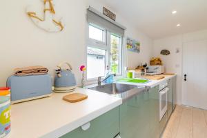 a kitchen with a sink and a counter top at The Happy Hedgehog in Mundesley