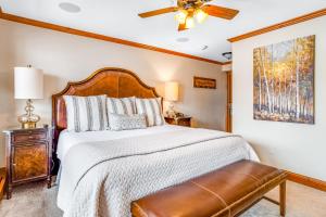 a bedroom with a large bed and a ceiling fan at Lion Square Lodge South 451 in Vail