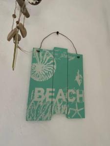 a sign that says becca hanging on a wall at Forever Beach Apartment in Sheerness