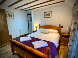 a bedroom with a bed with two towels on it at Seven Stars Inn in Builth Wells