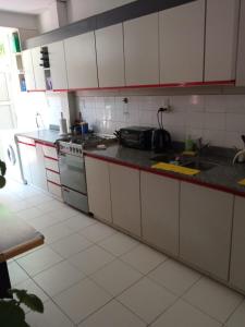 a kitchen with white cabinets and a stove at Maria Delicia in Godoy Cruz