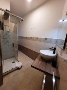 a bathroom with a sink and a shower at U Baruni B&B in Messina