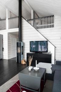 a living room with a table and a fireplace at Beautiful house with sea view in Piteå