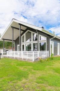 a manufactured home with a large window and a house at Beautiful house with sea view in Piteå