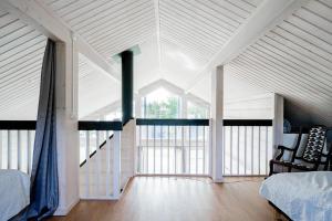 a attic room with a bed and a large window at Beautiful house with sea view in Piteå