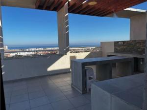 a balcony with a table and a view of the beach at ARRIENDO EXCLUSIVO DPTO en LA SERENA in La Serena