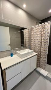 a bathroom with a white sink and a mirror at Alma de mar in Mar del Plata +17 photos