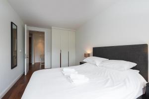 a bedroom with a large white bed with white pillows at Fernbank in Dublin