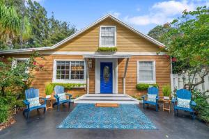 a house with blue chairs and a blue door at Tropical Oasis Located Near Lake With Pool and Hot Tub in West Palm Beach