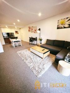 a living room with a couch and a coffee table at Contemporary in Kingston-2bd Apt in Kingston 