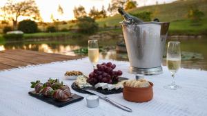 a table with glasses of champagne and food on it at Mt Hay Retreat in Berry +35 photos