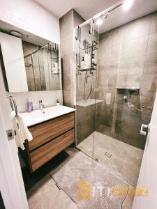a bathroom with a shower and a sink and a showerspective at Contemporary in Kingston-2bd Apt in Kingston 