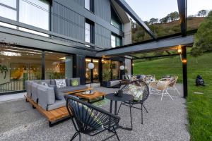 a patio with a couch and chairs and a table at Hotel Ecos del Sella in Cangas de Onís