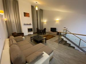 a living room with a couch and a table at Silver Mountain Apartment in Poiana Brasov