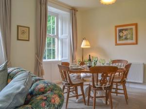 a living room with a table and chairs at Monkwood Cottage in Hale